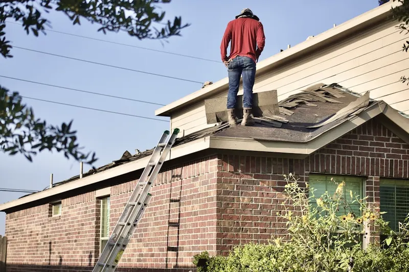 Professional roofer working on a residential roof in Viking Highlands